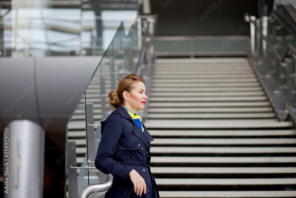 Fototapeta premium beautiful stewardess in the airport terminal looks out the window