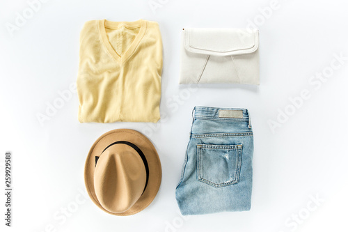 Woman clothes and accessories set on white background top view. modern and casual outfit. fashion, shopping and makeup concept. Flat lay, top view. 