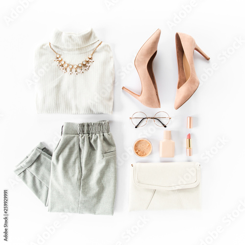 Woman clothes and accessories set on white background top view. modern and casual outfit. fashion, shopping and makeup concept. Flat lay, top view.  photo