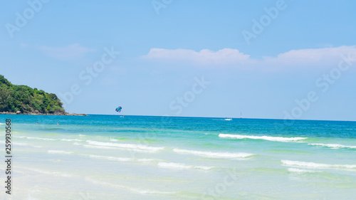 Fototapeta Naklejka Na Ścianę i Meble -  Tropical beach background with beautiful blue sea and parachute  , crystal clear sea and white sand with palms