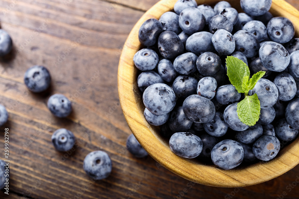 blueberries in a wooden plate blueberries in a wooden plate