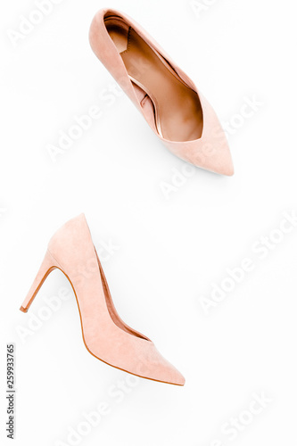 Pastel pink women high heel shoes on white background. Flat lay, top view trendy fashion feminine background. Beauty blog concept. Fashion blog look. 
