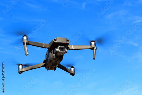Flight of the drone against the blue sky. © Алексей Кочев