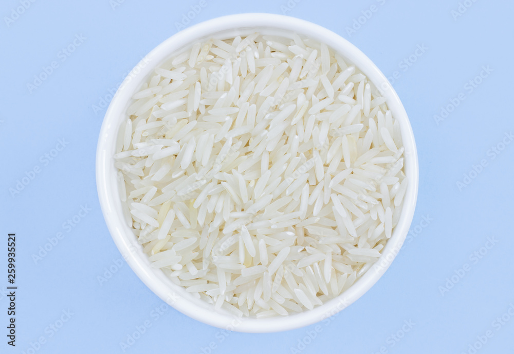 rice in a plate on top, on a blue background, copy space rice in a plate on top, on a blue background, copy space