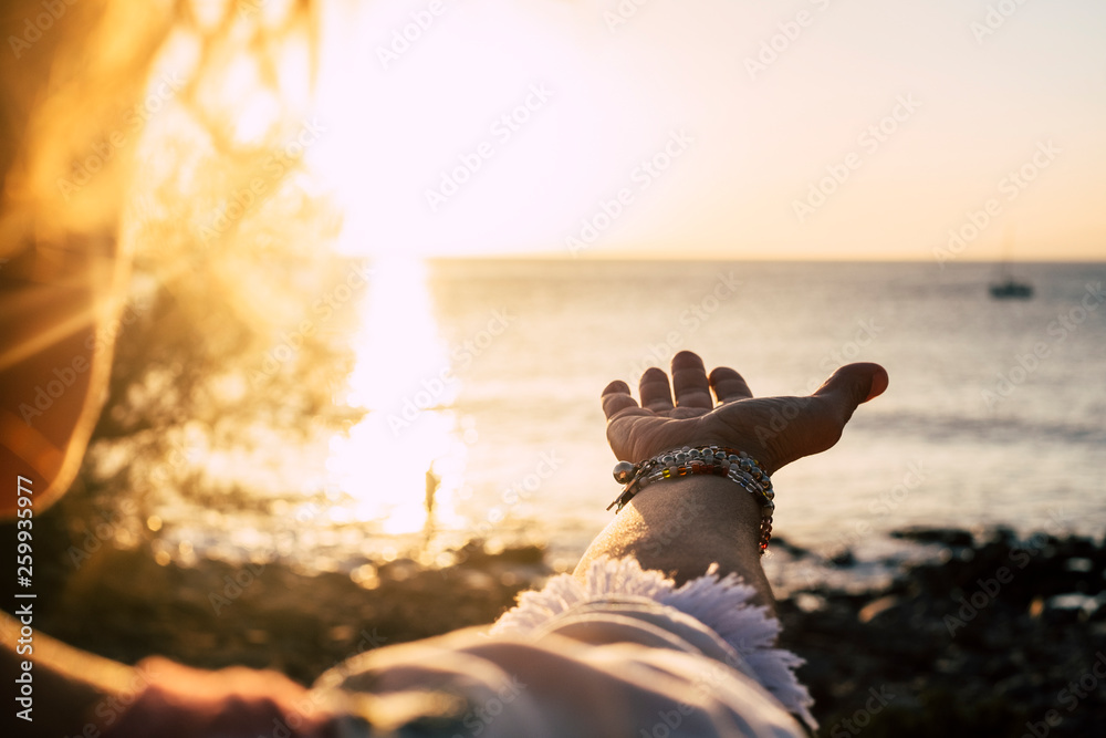 Sunset sunlight folden colors and ocean in background- woman with accessories with and to take the quiet sea - vacation and travel concept for wanderlust lifestyle - obrazy, fototapety, plakaty 