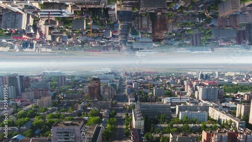 Aerial view over Moscow City districts in a summer sunny day, Russia, mirror horizon effect. Media. Beautiful landscape of modern buildings, green trees and roads, inception theme.