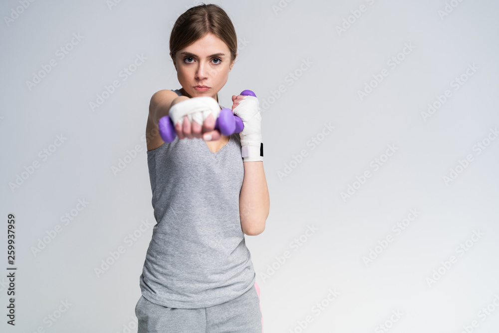 Portrait of pretty sporty girl holding weights dumbbells and make exercises. Portrait of pretty sporty girl holding weights dumbbells and make exercises.