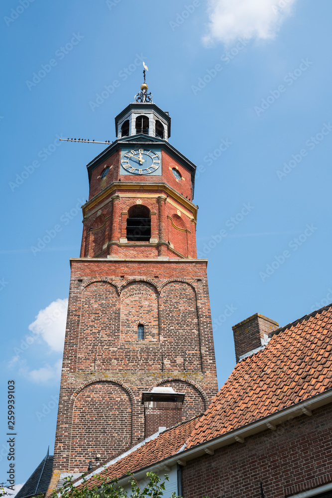 tower of Sint-Lambertuskerk, Buren, The Netherlands, against blue sky, space for text
