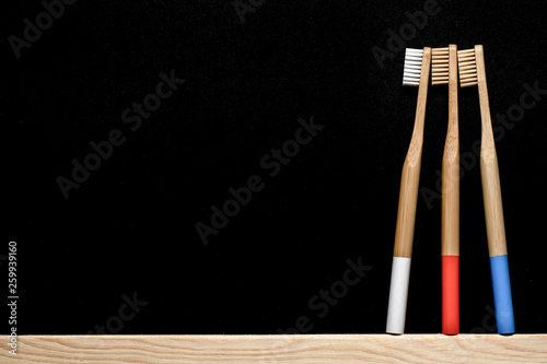 Bamboo toothbrushes on a slate background. Place for text.