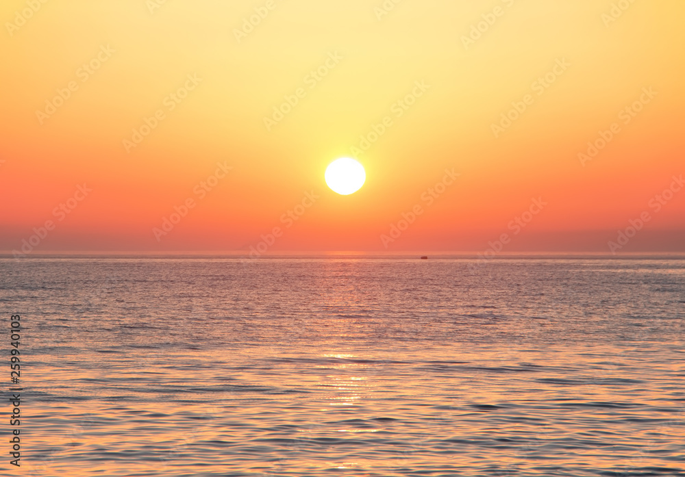 Black Sea at sunset. Large yellow sun under the sea surface. Sochi, Russia. Black Sea at sunset. Large yellow sun under the sea surface. Sochi, Russia.