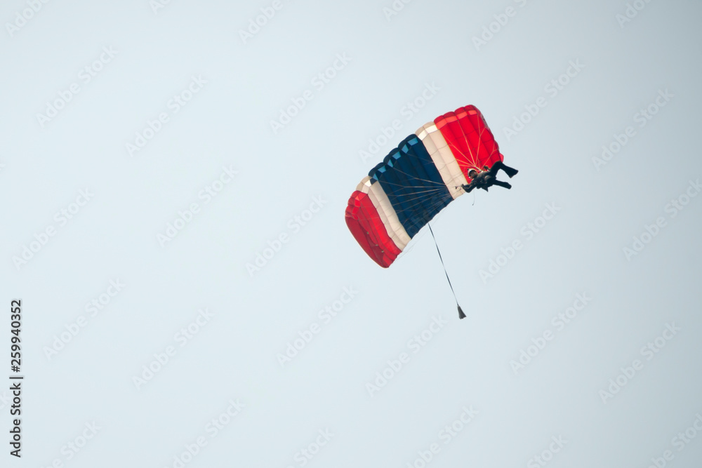 Parachutist on blue sky preparing for landing Parachutist on blue sky preparing for landing