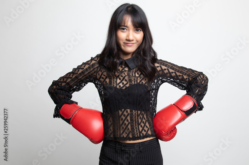 Young Asian woman with red boxing gloves. © halfbottle