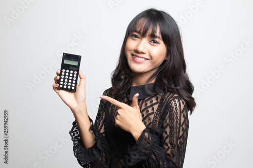 Asian woman point to calculator.