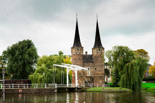 city gate with towers, lifting bridge and water in Delft, The Netherlands
