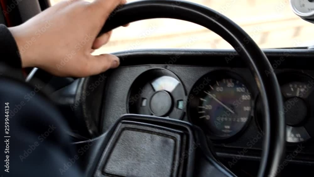 The man behind the wheel of an old car. Traveling by car. Vehicle. The man behind the wheel of an old car. Traveling by car. Vehicle.