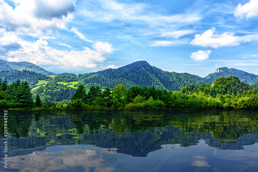 Idyllic panorama of picturesque mountains and blue sky reflected in the lake (mixed) Idyllic panorama of picturesque mountains and blue sky reflected in the lake (mixed)