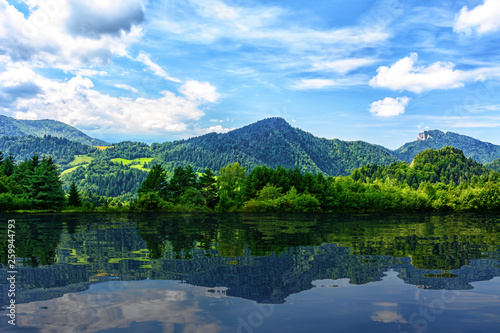 Idyllic panorama of picturesque mountains and blue sky reflected in the lake  mixed 