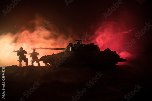 War Concept. Military silhouettes fighting scene on war fog sky background  World War German Tanks Silhouettes Below Cloudy Skyline At night. Attack scene. Armored vehicles. Tanks battle
