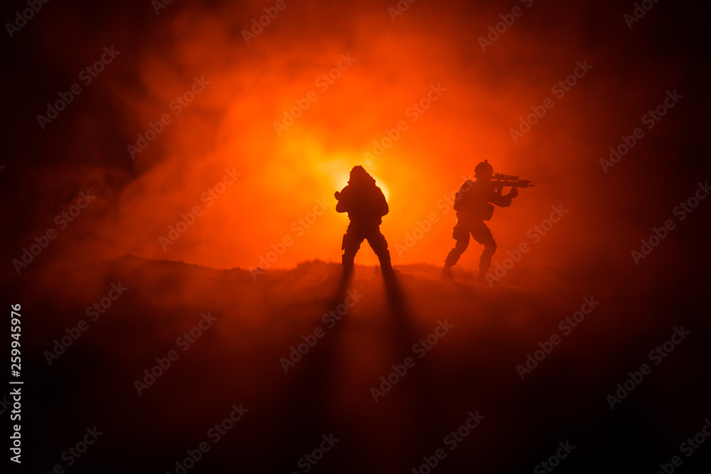 Fototapeta premium Military soldier silhouette with gun. War Concept. Military silhouettes fighting scene on war fog sky background, World War Soldier Silhouette Below Cloudy Skyline At night.