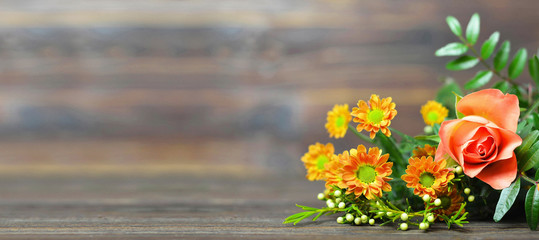 Mothers Day flowers on wooden background with copy space
