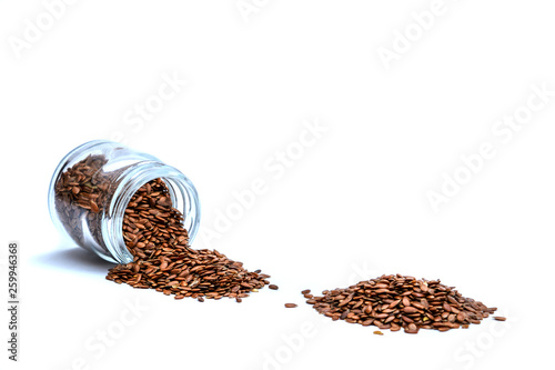 Isolated photo. Flax seeds in a glass jar on a white background. Healthy food, diet for weight loss.