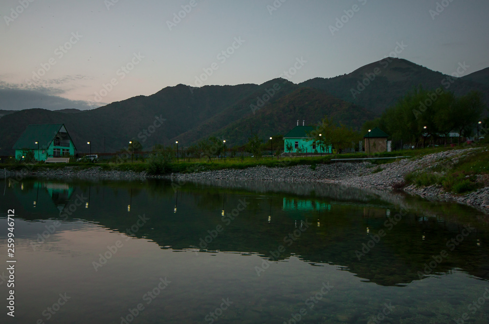 Fototapeta premium Beautiful clouds flying over the lake near mountains. Evening time shot over the clouds. Azerbaijan. Big Caucasus