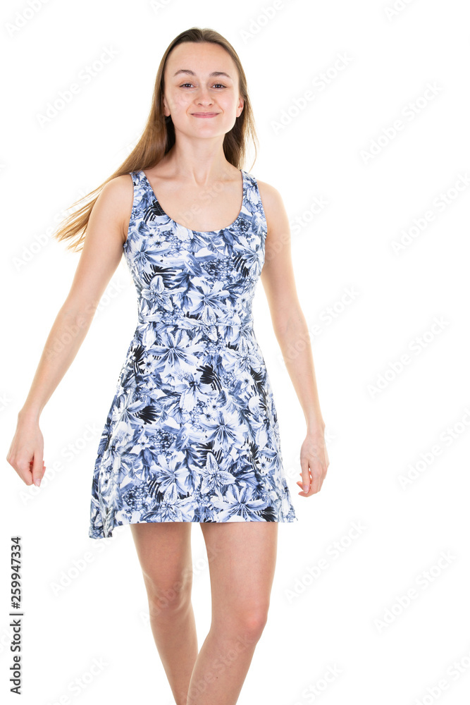 Beautiful young smiling teen girl in blue flower dress on white background Beautiful young smiling teen girl in blue flower dress on white background