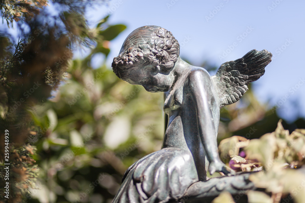 Statue small angel in natural park backgorund Statue small angel in natural park backgorund