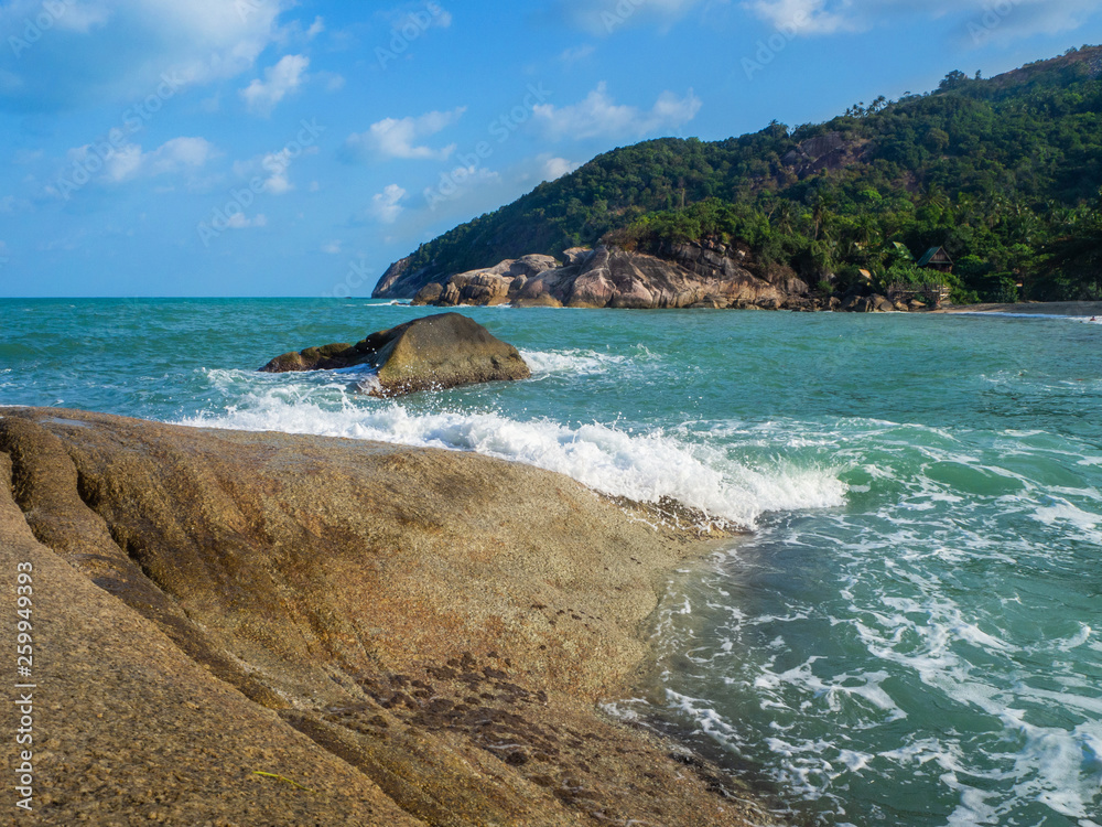 The waves beat on the rocks of the coast of Koh Pangan. Thailand