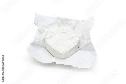 Soft cheese with white mold Brie in unwrapped packaging