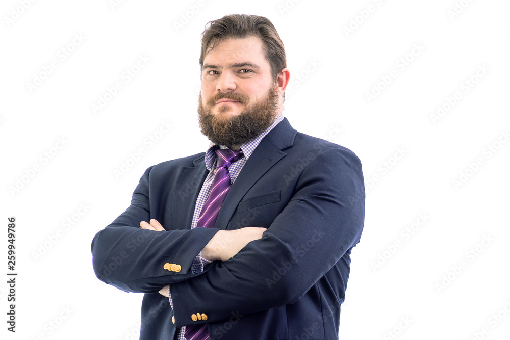 Portrait of a big handsome serious bearded business man in a dark suit and a bright blue tie, isolated on white Portrait of a big handsome serious bearded business man in a dark suit and a bright blue tie, isolated on white