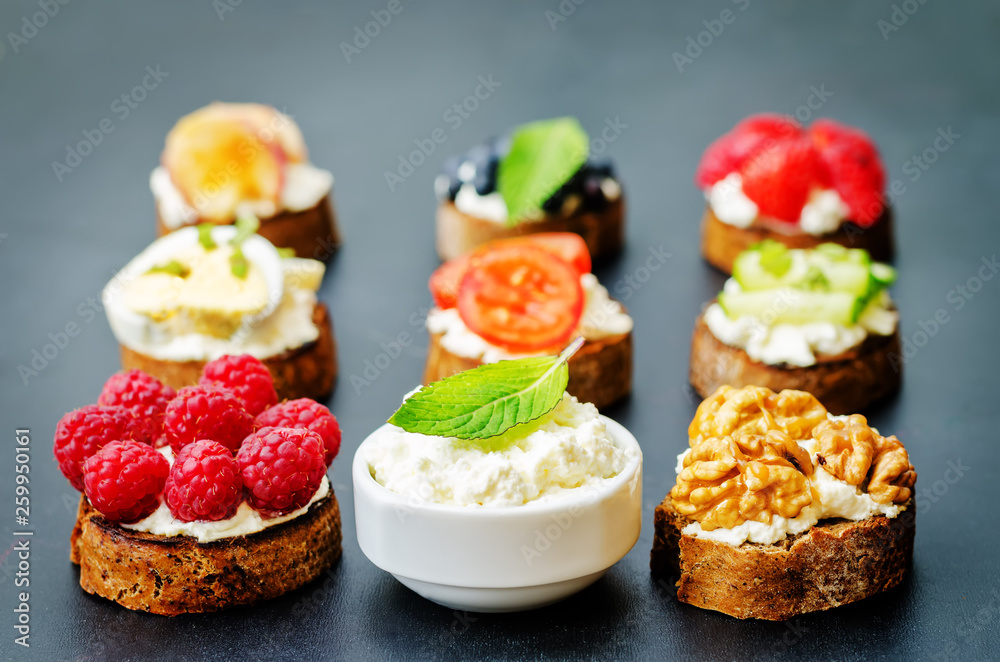 Ricotta and crostini appetizers with fillings on a black background. Ricotta and crostini appetizers with fillings on a black background.