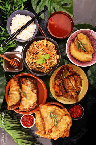 Assorted Chinese food set. Chinese noodles, fried rice, peking duck, dim sum, spring rolls. Famous Chinese cuisine dishes on table. Chinese restaurant concept. 