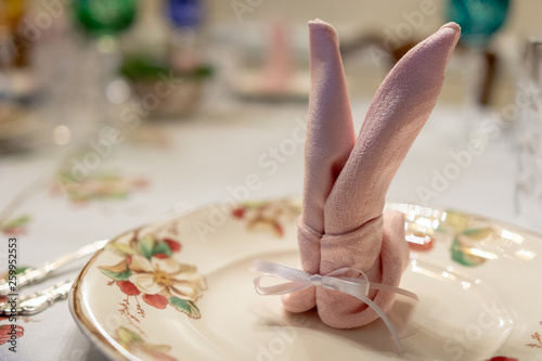 Pink napkin elegantly folded like a bunny.