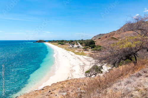 One dollar beach. Idillic yellow sandy beach of East Timor, Timor-Leste. Coastline with hills, mountains and dry savanna. Rural landscape and nature between Dili and Manatuto. Maritime Southeast Asia © Dmitry