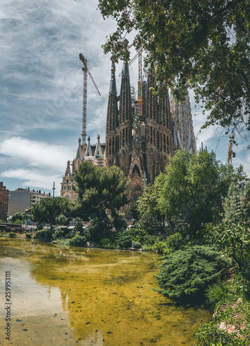 La Sagrada Familia on a beautiful sunny day, people visiting the church designed by Antoni Gaudì