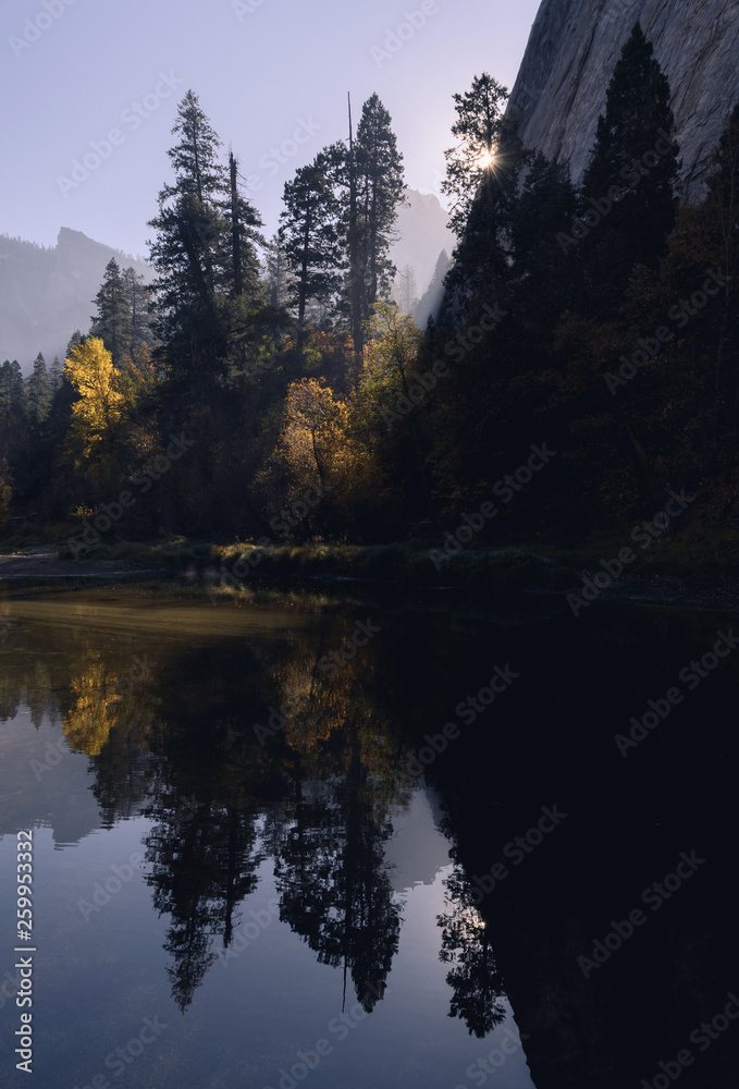 Autumn colors reflected in the Merced River in early morning light in Yosemite National Park