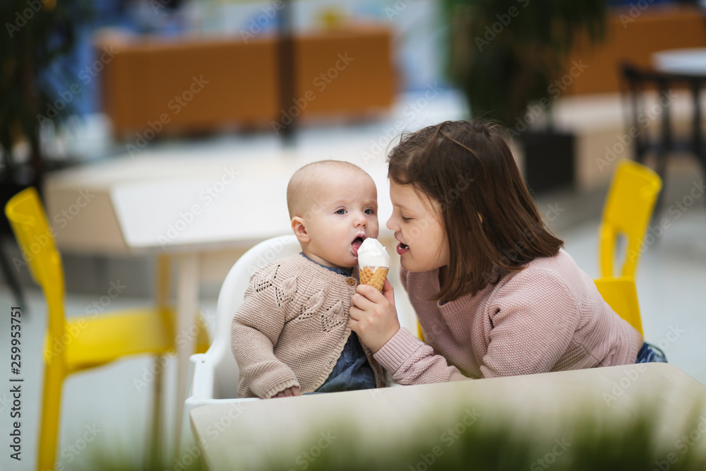 sisters eat ice cream in cafe shopping in center sisters eat ice cream in cafe shopping in center