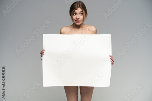 Sexy naked girl with a poster. Clean skin. Hair removed. Isolate. For advertising and presentation. photo