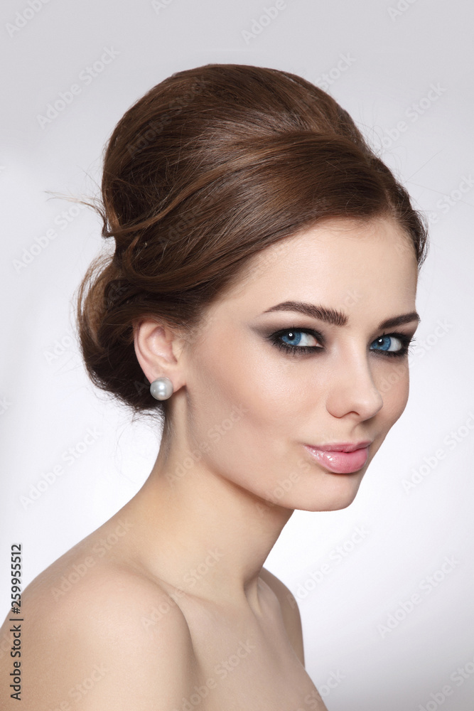 Vintage style portrait of young beautiful woman with fancy hair bun and  smoky eye makeup Stock Photo | Adobe Stock