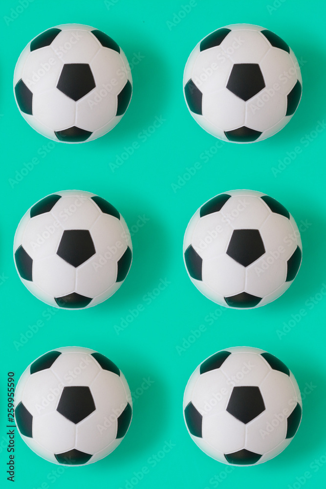 Naklejka premium Many black and white soccer balls background. Football balls in a water