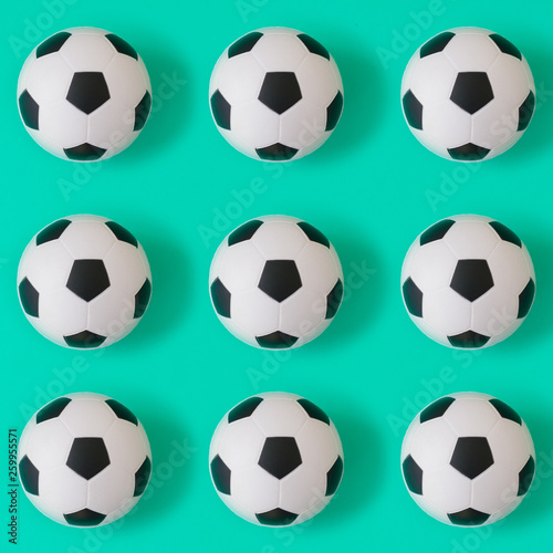 Many black and white soccer balls background. Football balls in a water