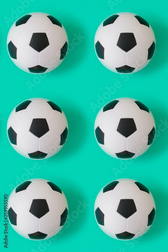 Many black and white soccer balls background. Football balls in a water