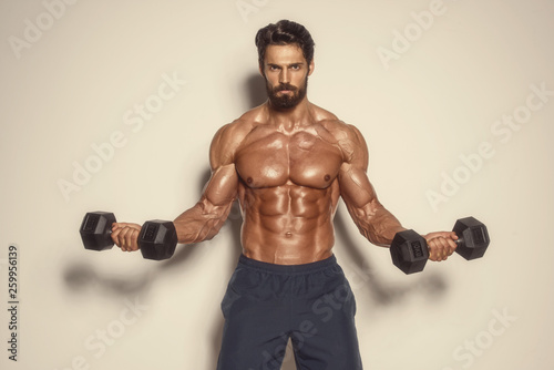 Fotografie Handsome Muscular Men Exercise With Weights