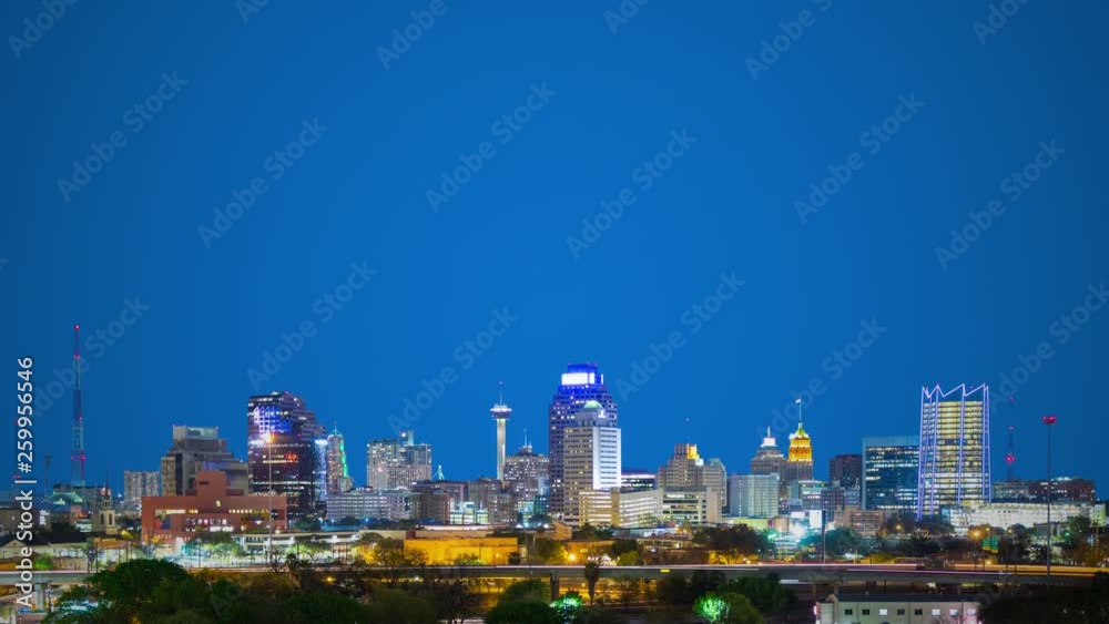 San Antonio TX Generic Wide Cityscape Timelapse on Lower Third featuring the Skyline Architecture at Night with Streaking Lights from Passing Interstate Traffic with a Large Clear Blue Empty Space Bac San Antonio TX Generic Wide Cityscape Timelapse on Lower Third featuring the Skyline Architecture at Night with Streaking Lights from Passing Interstate Traffic with a Large Clear Blue Empty Space Bac