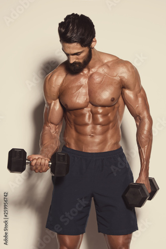 Handsome Muscular Men Exercise With Weights