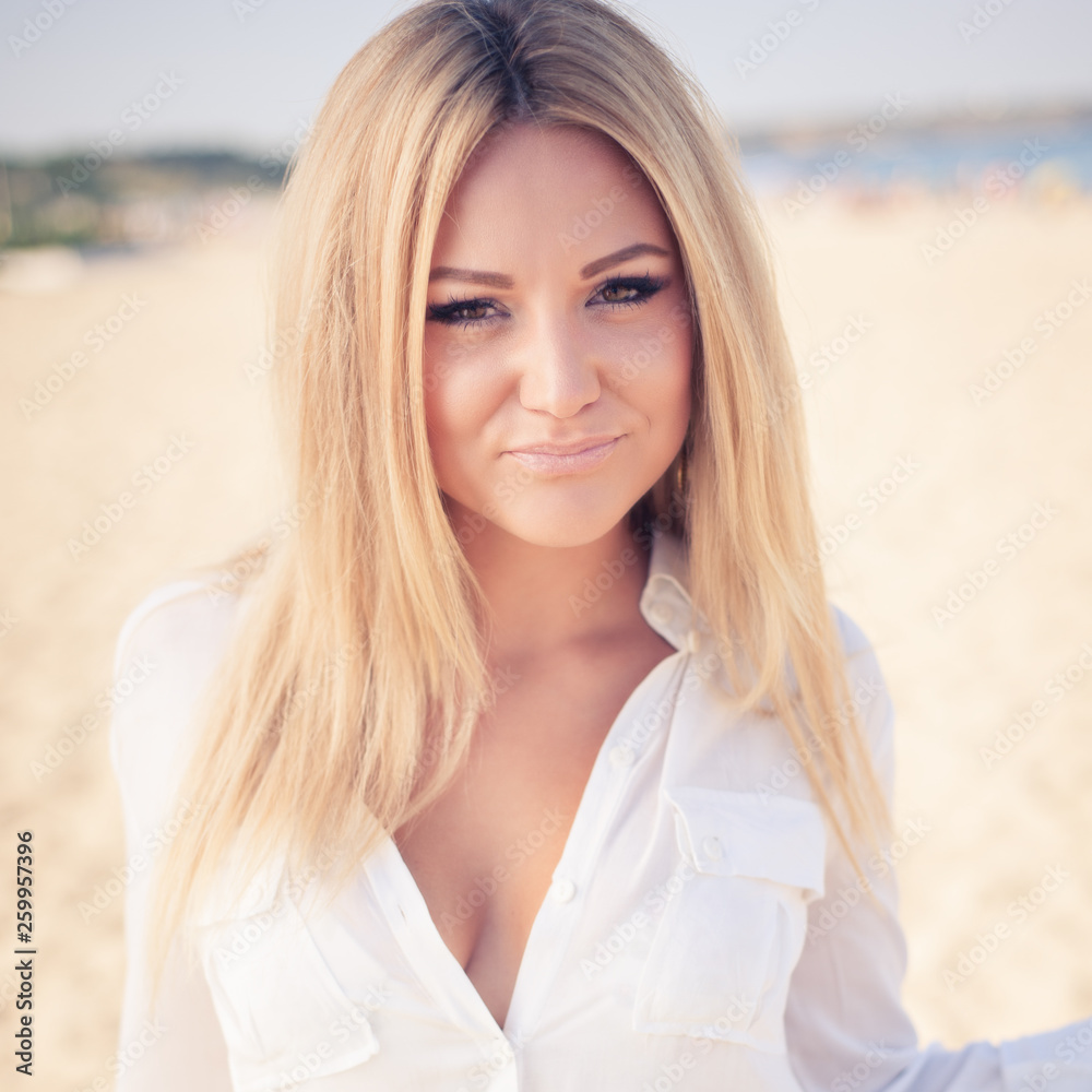 young beautiful woman blonde poses on a beach young beautiful woman blonde poses on a beach