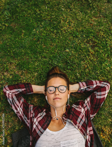 Female relaxing and listening to music photo