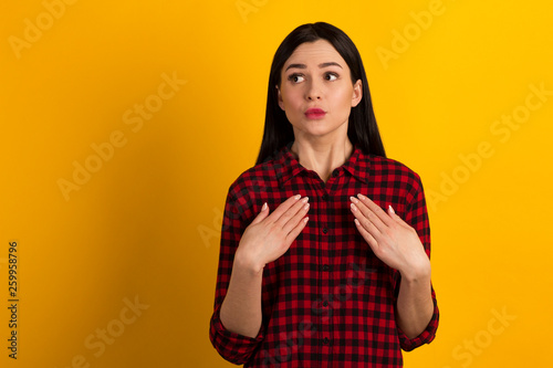 Close up photo sweet beautiful amazing she lady arms hands fingers pointing self it is not my fault guilty wearing casual red shirt isolated yellow bright vivid background