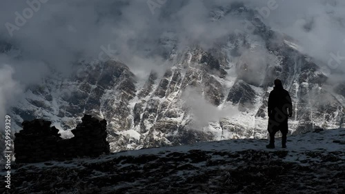 Hiker looks and goes on  the one of the majestic mountains in the Annapurna mountain range in Nepal